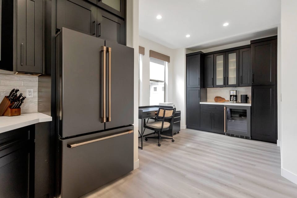 Coffee and wine bar with wine fridge along with a desk if you need to work from home