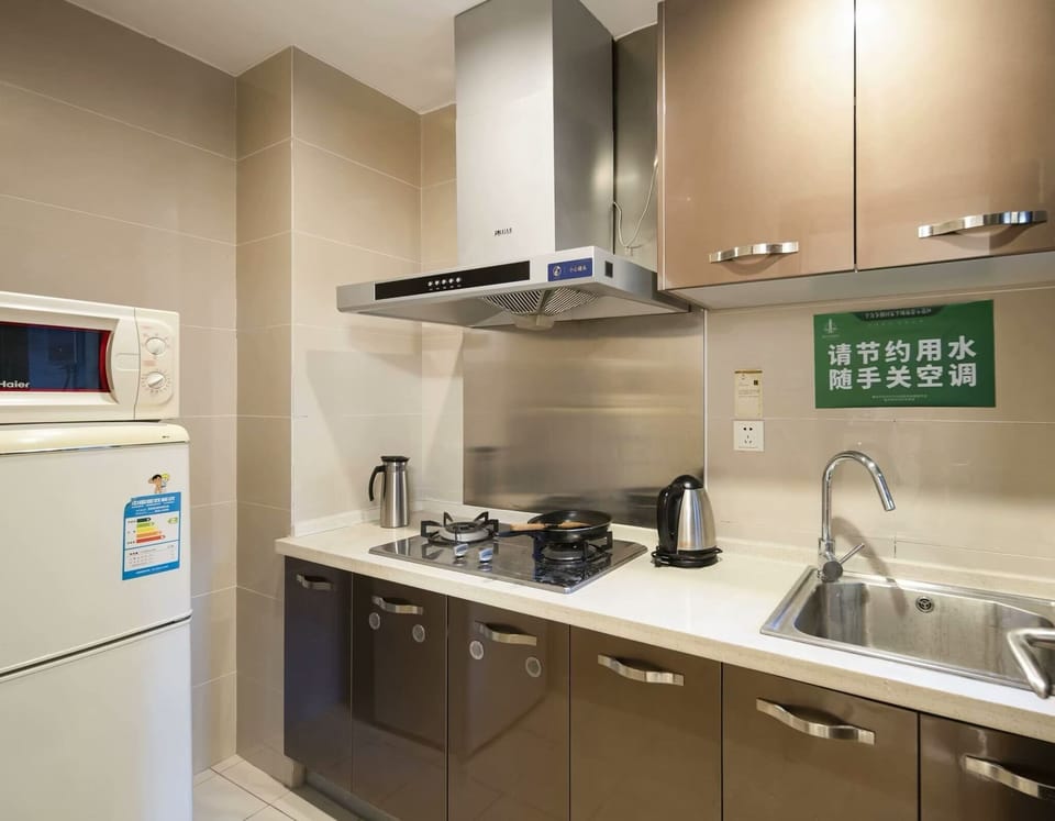 Luxury Studio Suite, 1 King Bed with Sofa bed, Partial Ocean View | Private kitchen | Fridge, stovetop, cookware/dishes/utensils, dining table
