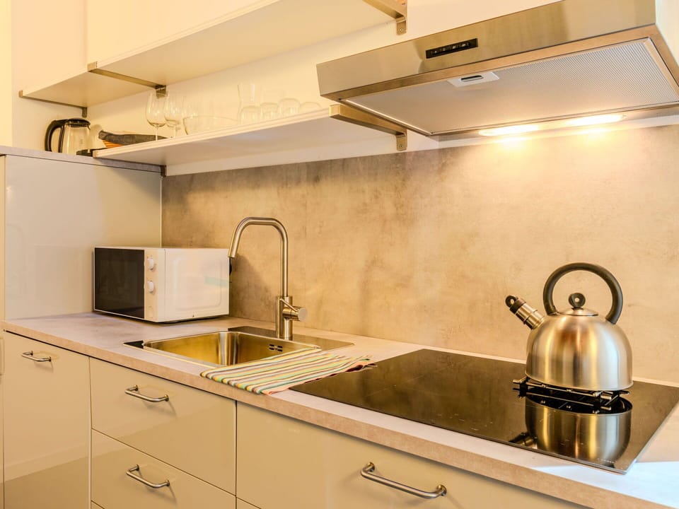 Kitchen, Countertop, Kitchen Appliance, Interior Design, Flooring, Wood, Cabinetry, Plumbing Fixture, Kitchen Sink, Lighting