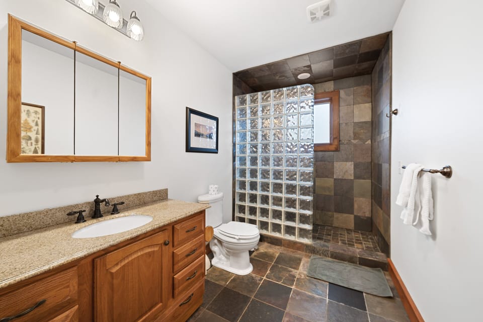 Full Hallway Bathroom, Adjacent to both Queen Bedrooms, boasts Granite Vanity and a Massive Slate Tile Shower