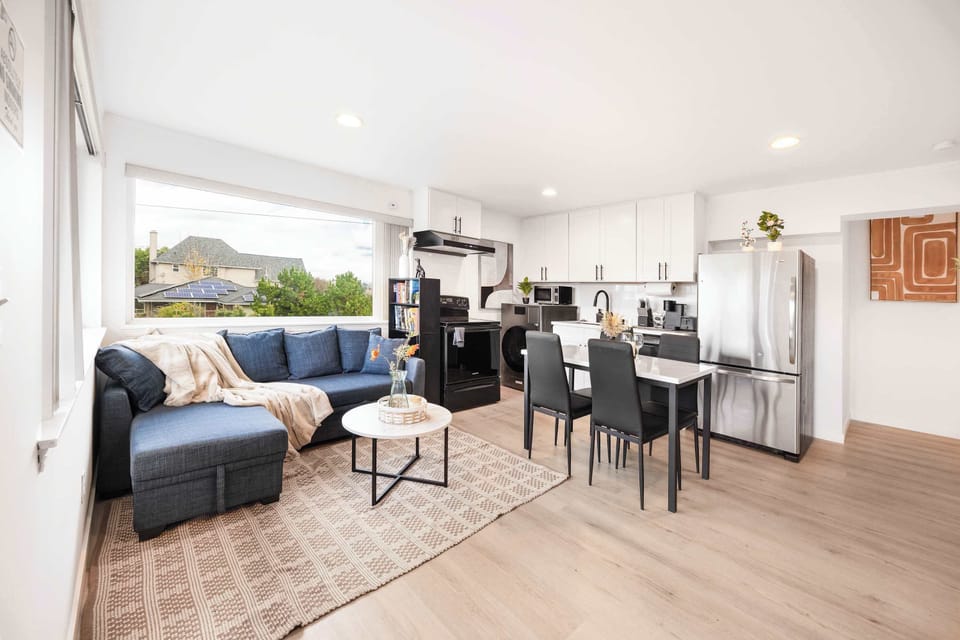 The living area features a stylish and comfortable setup, flowing into a dining space ideal for meals or gatherings. The adjacent kitchen offers modern appliances and functionality for easy cooking and entertaining.