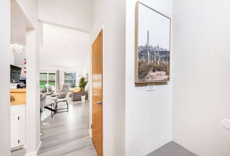 This snapshot captures the seamless flow from the hallway to the cozy living area, showcasing the open layout and inviting ambiance of the home.

