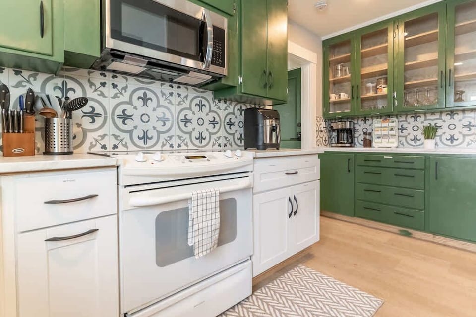 A compact laundry area with a washer, dryer, and laundry basket, providing convenience for longer stays.