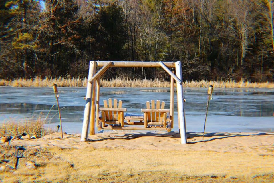 Backyard oasis with a fire pit and Adirondack chairs.