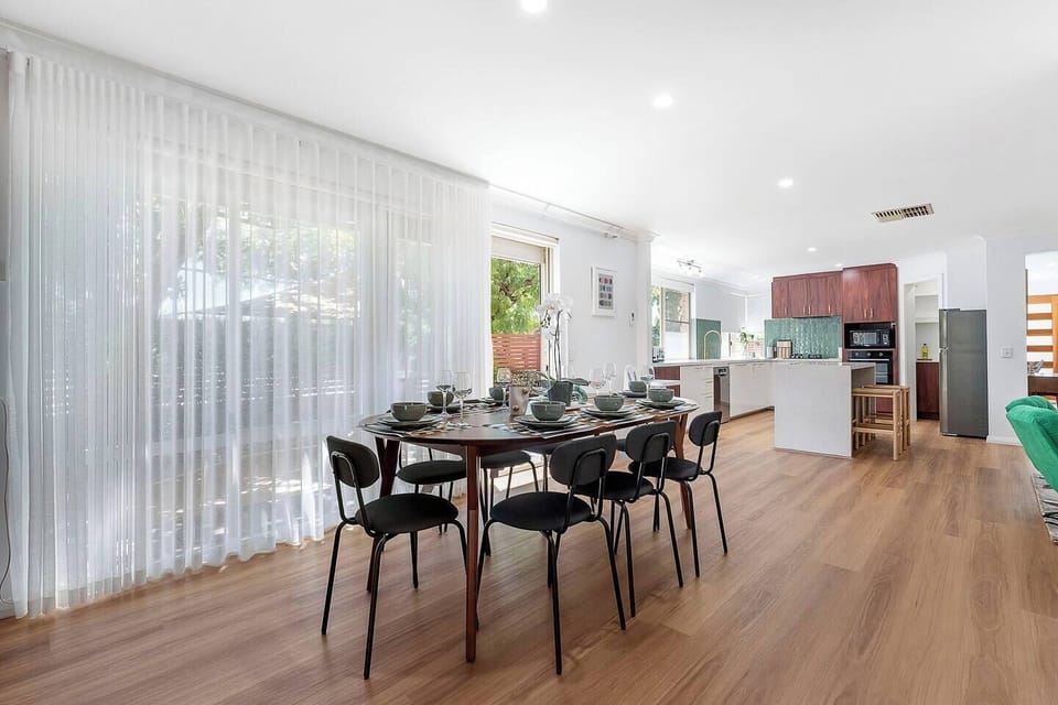 Spacious and stylish, this dining area connects seamlessly with the outdoors for a fresh vibe.