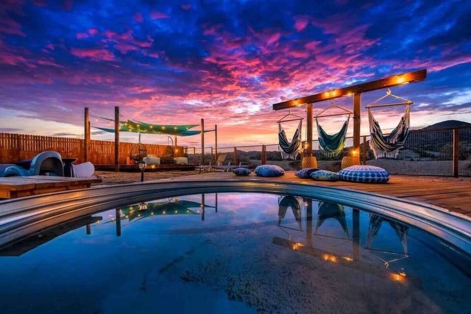 Pool deck with swings and furniture overlooking the beautiful mountain view!