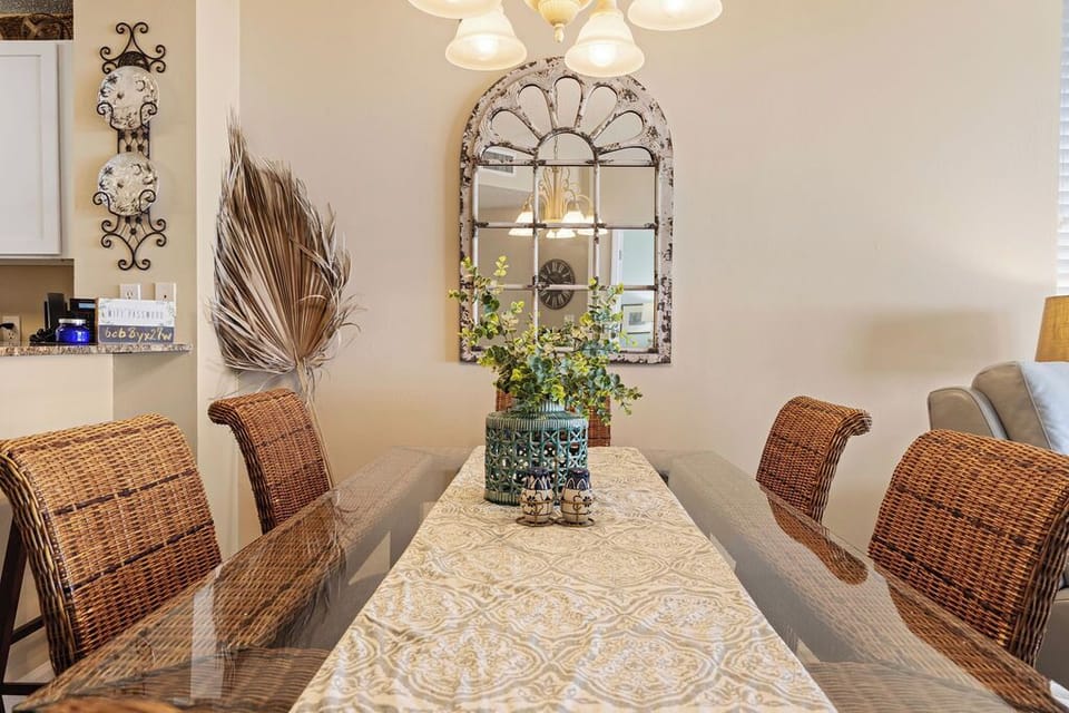 Dining Area - The open dining area features a table with seating for 6, with additional seating located at the adjacent bar.