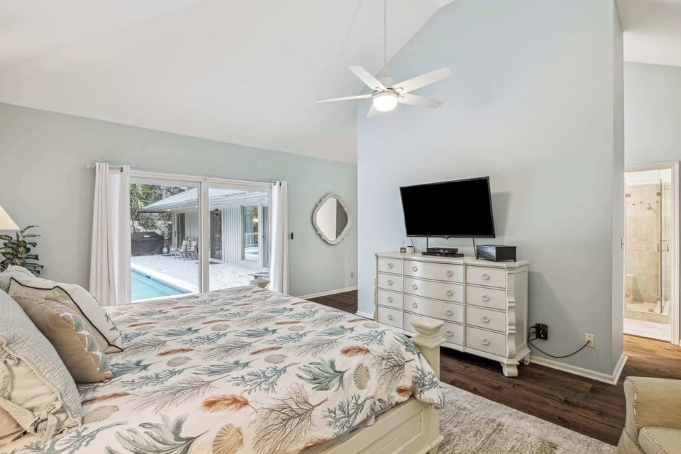 Bedroom 3 with king bed, TV, patio access, and ensuite
