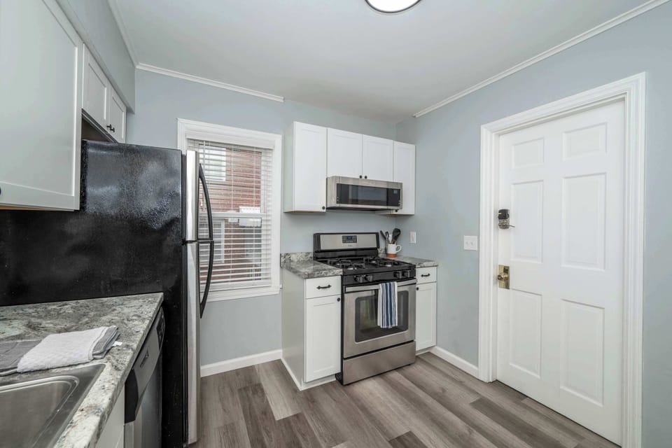 Apartment 1’s sleek kitchen offers ample space & all the comforts of home