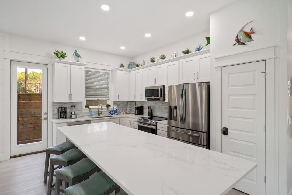 The kitchen island has extra seating and a lot of counter space.