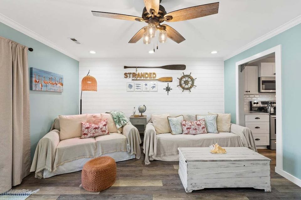 Cozy living room that features a big screen smart TV & a sleeper sofa.