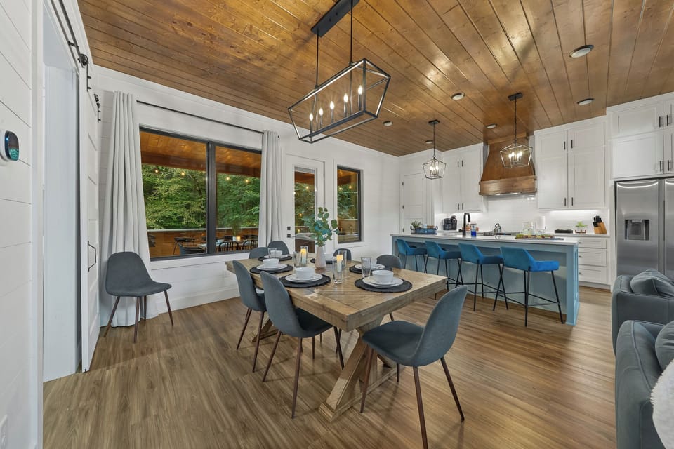 An open dining area with forest views. Perfect for gathering over homemade meals and conversations that last for hours.