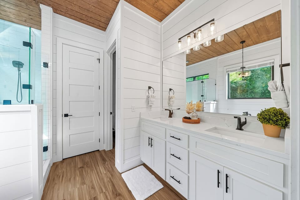 A bright vanity with modern fixtures and natural light. Perfect for a calm start to the day or winding down before bed.