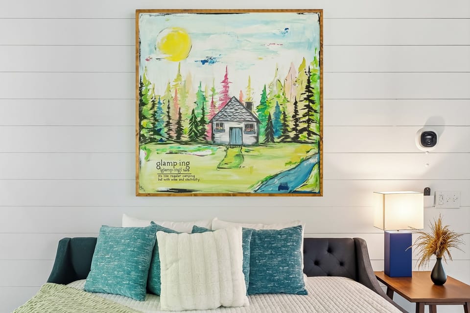 Cheerful art piece adds warmth and charm to this cozy nook. Perfect for quiet moments, reading, or simply soaking in the cabin’s character.
