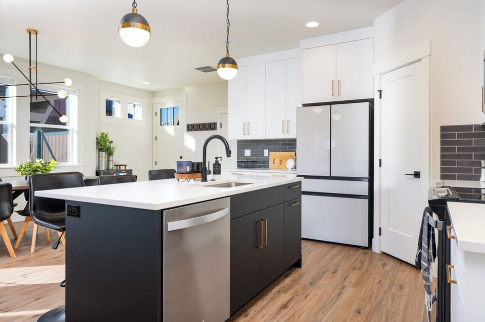 Enjoy a fresh, contemporary kitchen with a soothing gray-and-white color scheme and sleek, modern details