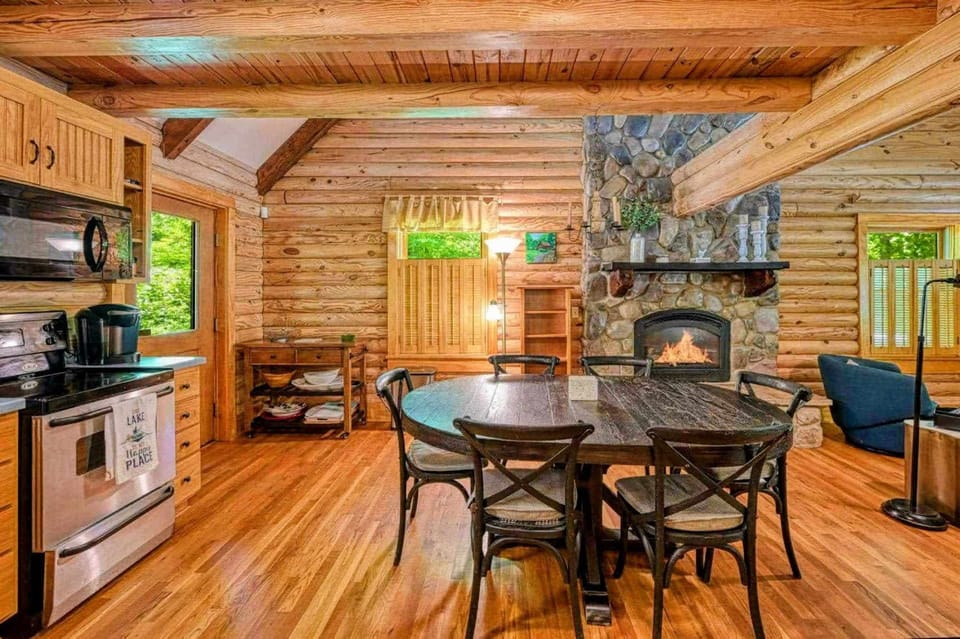 Enjoy a warm meal by the fire in this rustic log cabin kitchen, where cozy meets comfort for your perfect getaway.
