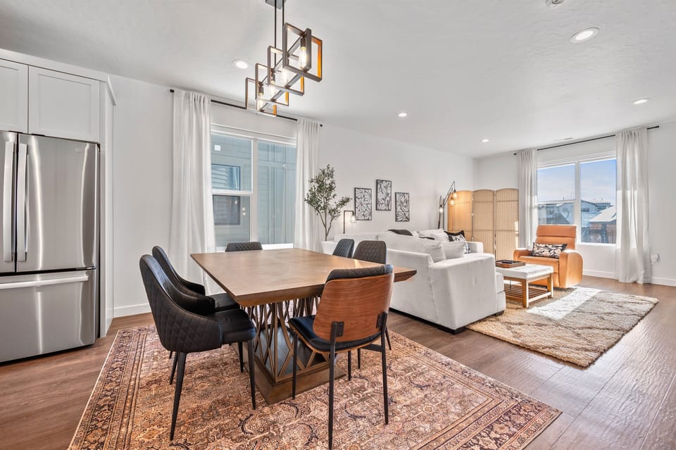 The open-concept living space, complete with a dining area, facilitates effortless conversation with family and friends.