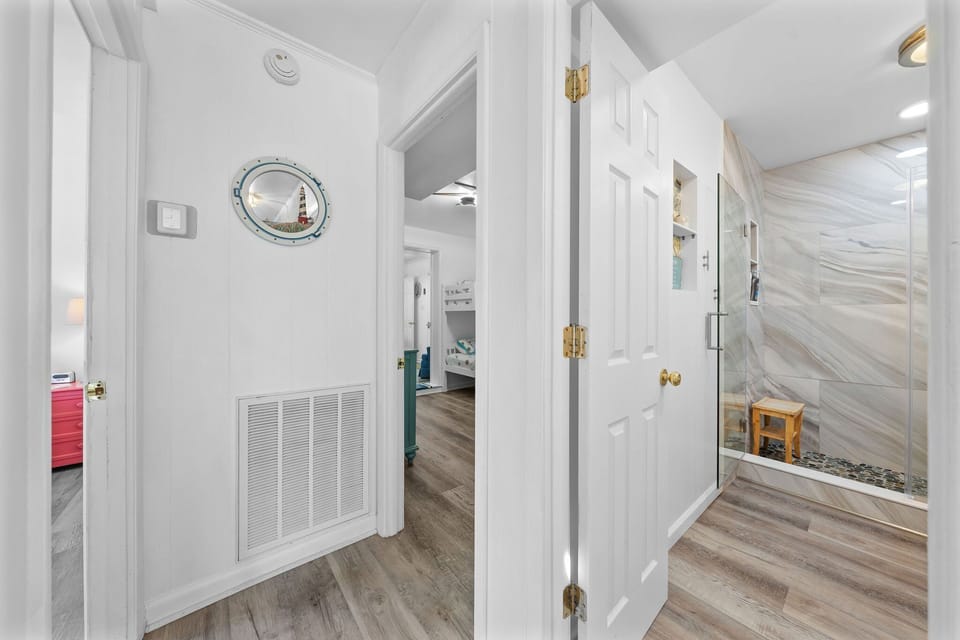 Bright entryway with nautical decor leads to playful bunk rooms and stylish bath!