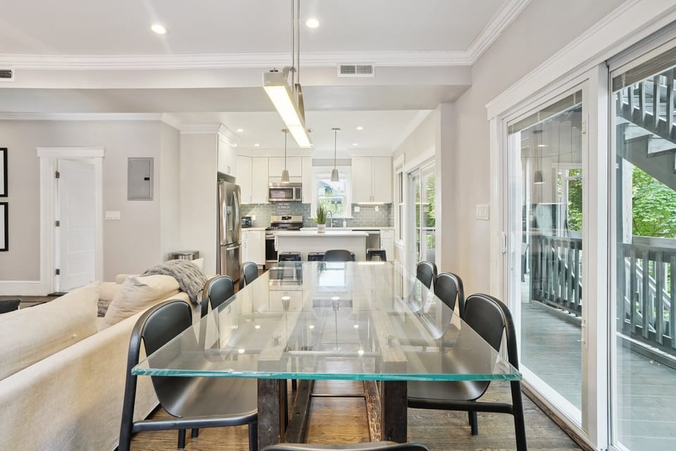 Dining Area Unit 2 | Open Concept Dining Area with Glass Table Seating 10 | Unit 2 — Second Floor of Building — Unit on One Level