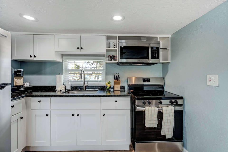 Cook with ease in the fully equipped kitchen featuring stainless steel appliances, ample counter space, and all the essentials for preparing delicious meals.





