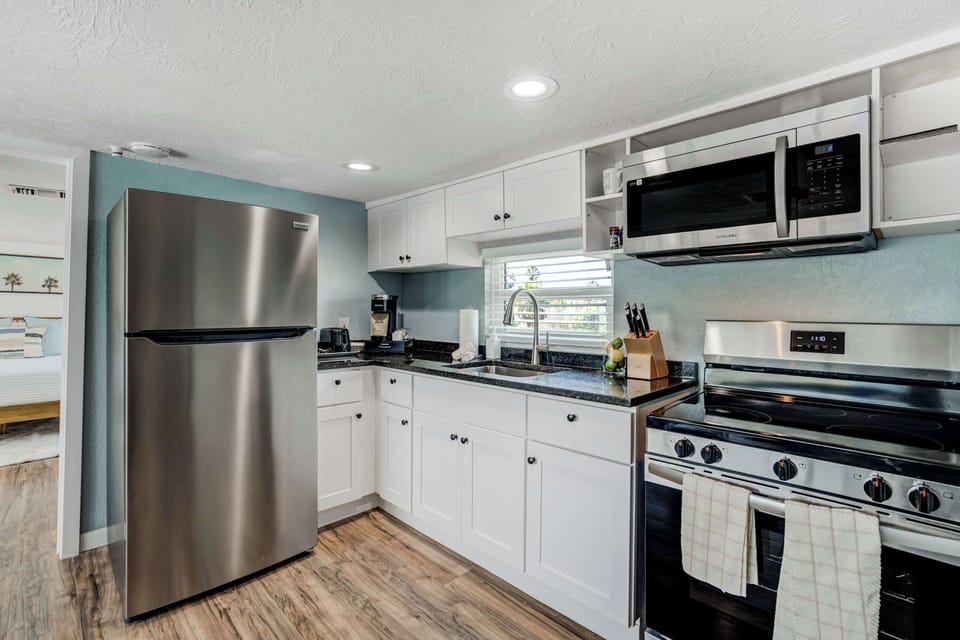 Cook with ease in the fully equipped kitchen featuring stainless steel appliances, ample counter space, and all the essentials for preparing delicious meals.





