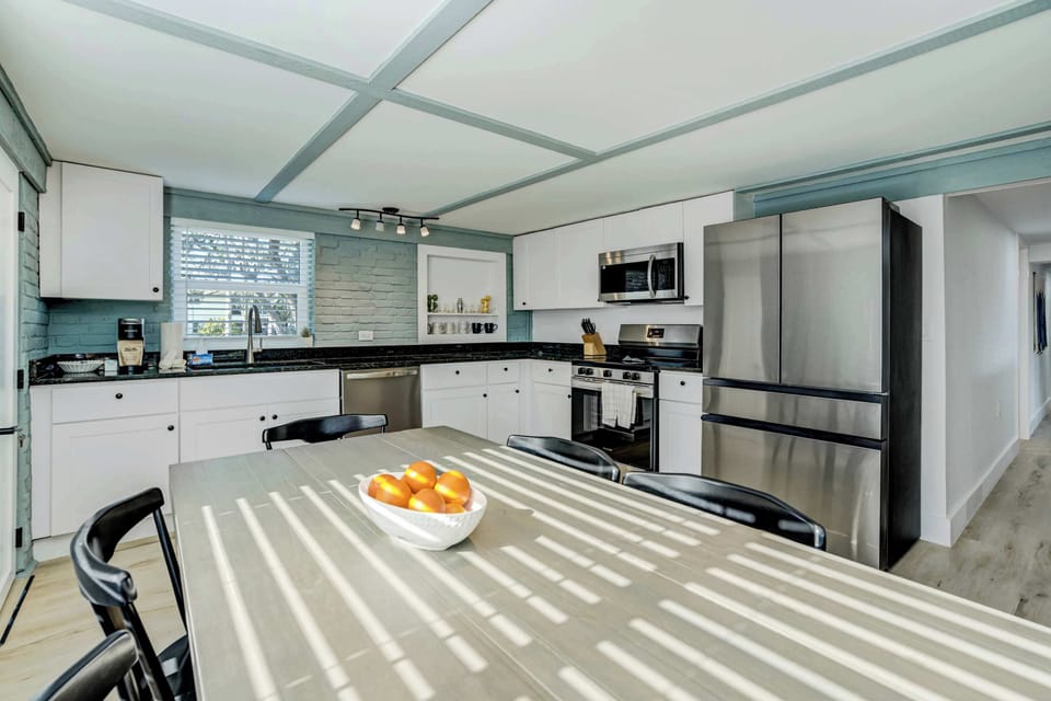 A stylish dining space with large windows, natural light, and plenty of seating—perfect for gathering over meals or planning your next adventure.
