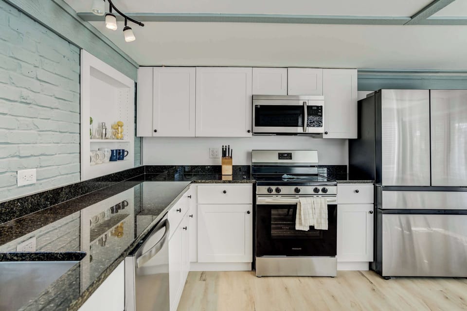 A stylish and fully equipped kitchen with modern appliances, granite countertops, and ample storage—perfect for preparing delicious meals.





