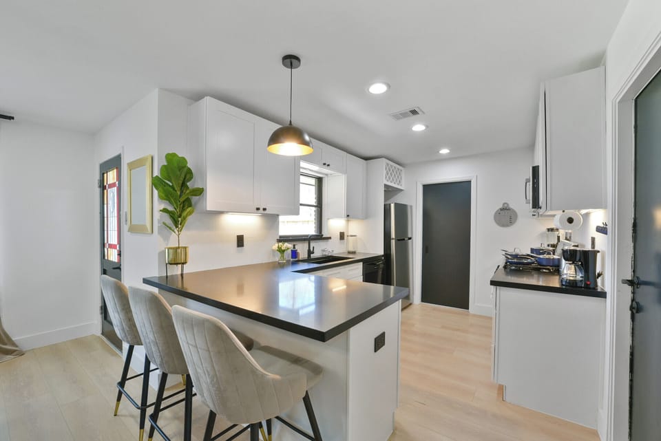 Fully equipped kitchen with modern appliances, cookware, and utensils, ready for any culinary needs.
