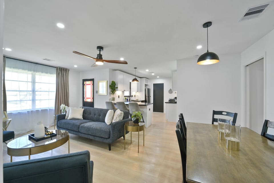 Unwind in the open-concept living room, featuring a sofa, smart TV, and a cozy reading nook. Ideal for gatherings, with board games and ample seating, creating a welcoming space for everyone to relax and connect.