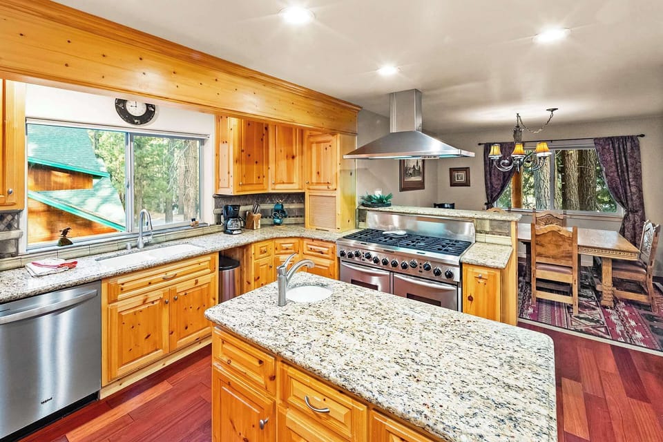 Beautiful modern open eat in kitchen. With huge refrigerator and stainless steel appliances. Ready for your mountain feast.