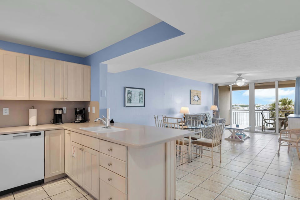 Extending Water views from kitchen, dining, to living room.  Fully stocked kitchen with option for bar seating or the dining table. 