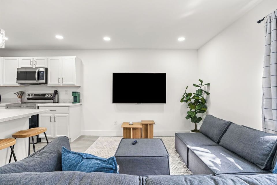 Relax in our cozy living room, featuring plush couches, a flat-screen TV, and stylish decor—perfect for unwinding after a day of exploration.