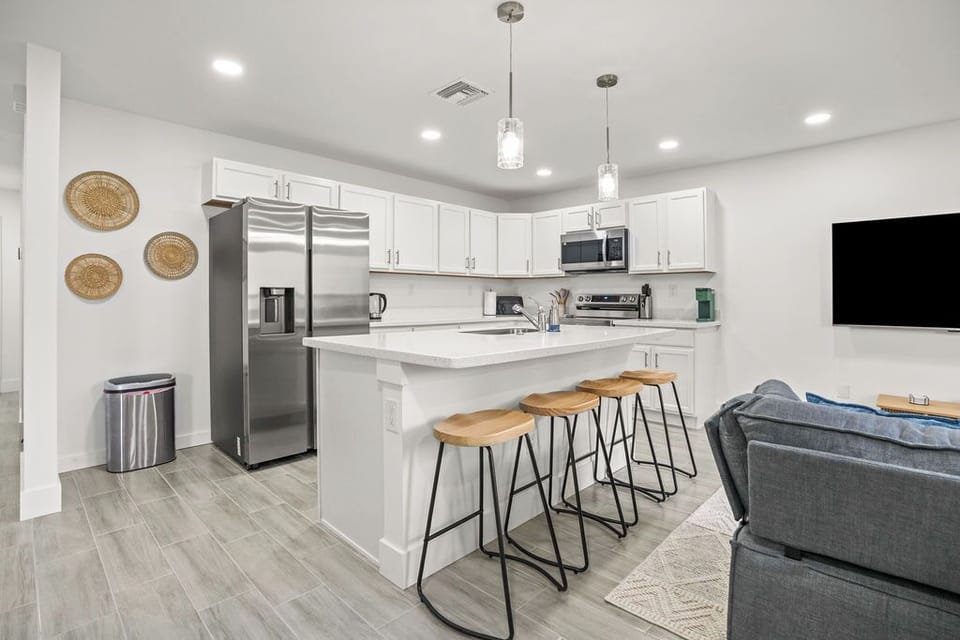 Our cozy kitchen is ideal for making meals or enjoying coffee at the dining table, with modern appliances and stylish cabinetry for both function and comfort.