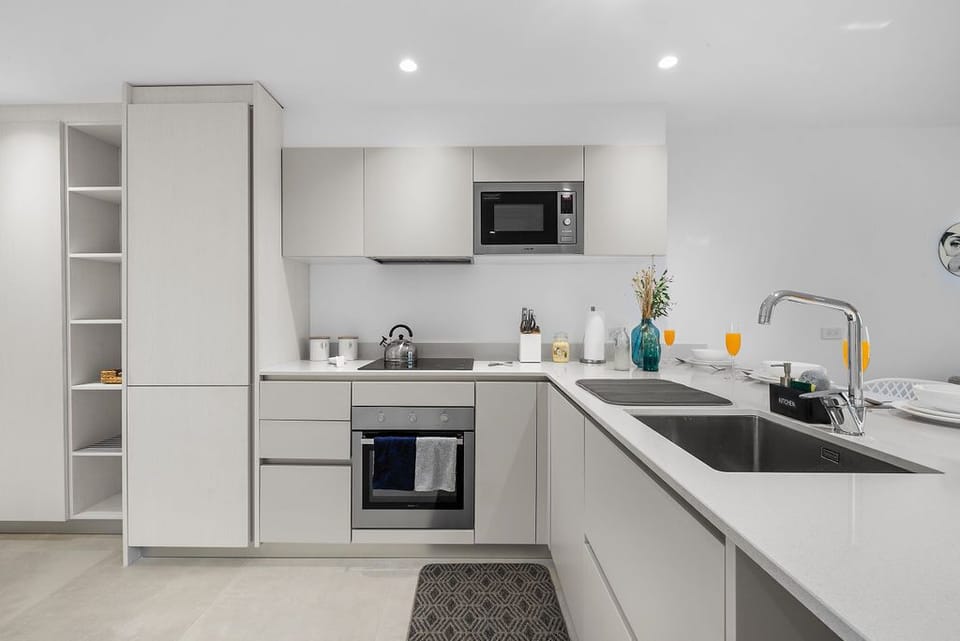 Your bright, modern kitchen has everything for easy meal prep—sleek countertops, an oven and microwave, a stove, and plenty of storage so you can cook and unwind effortlessly.