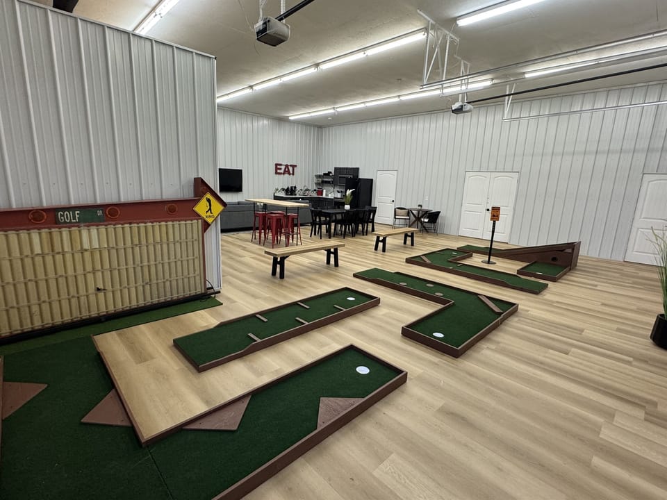 Huge open floor plan with 5 putting greens and golf simulator