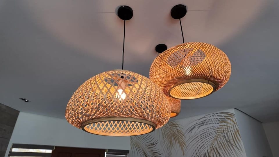 The rattan lighting in the living area adds the perfect touch of warmth and island charm. Its' woven texture creates a soft, inviting glow, making the space feel cozy yet stylish.