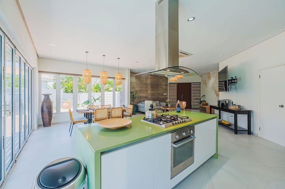 From this angle, the kitchen, dining, and living areas flow seamlessly into one inviting space—perfect for sharing meals, laughter, and making unforgettable vacation memories together.