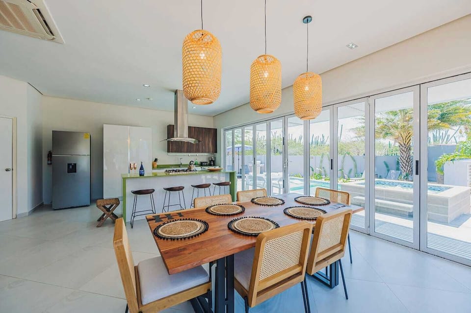 The open-concept dining area lets you enjoy meals surrounded by natural light, fresh air, and stunning views of the pool and lush greenery. With water and nature as your backdrop, every bite feels more relaxing.