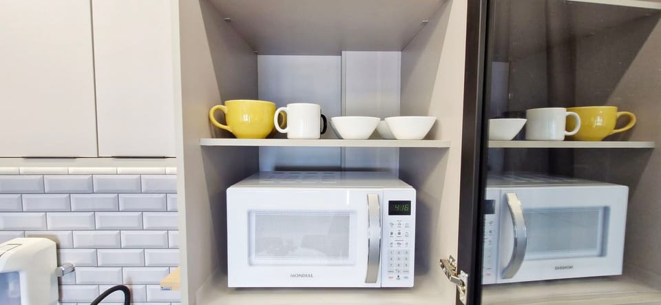 Panoramic Apartment | Private kitchen | Fridge, coffee/tea maker, cookware/dishes/utensils, dining tables