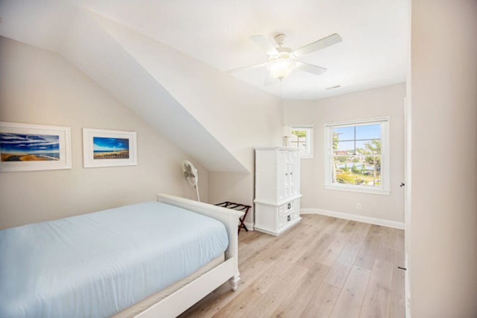 One of two bedrooms located on the upper level with a queen bed.