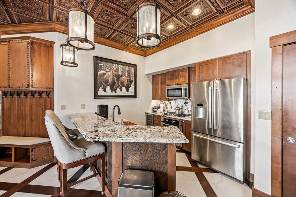 Open kitchen with island seating and slopeside light.
