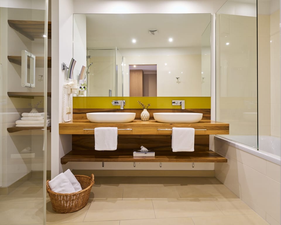 Familiensuite mit 2 Schlafzimmern | Bathroom | Eco-friendly toiletries, hair dryer, slippers, towels