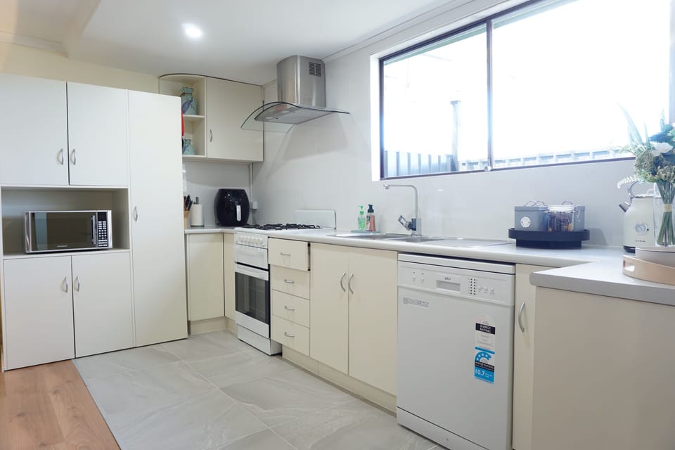 Fully equipped kitchen with oven, microwave, air fryer, toaster, kettle, etc...