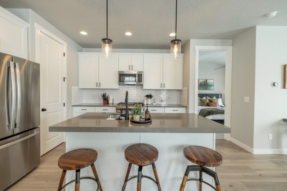 Fully equipped kitchen with stainless appliances and ample storage.