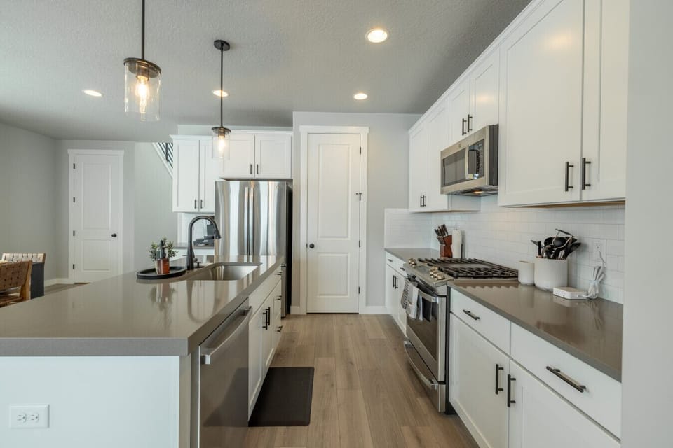 Spacious kitchen with island seating and open-concept layout.