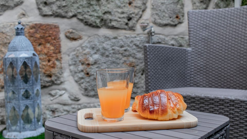 Savor a delightful morning treat al fresco on your private patio, surrounded by rustic stone walls and lush greenery.
#OutdoorSeating #BreakfastNook #LovelyStay