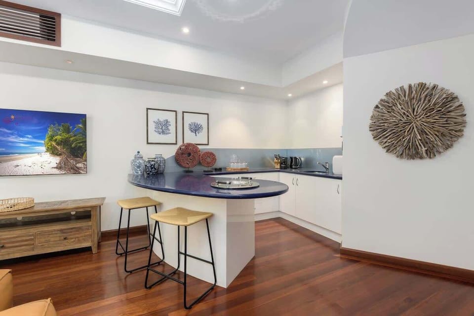 Mix drinks or prepare simple refreshments at the wet bar, complete with a sink, kettle, and bench seating.