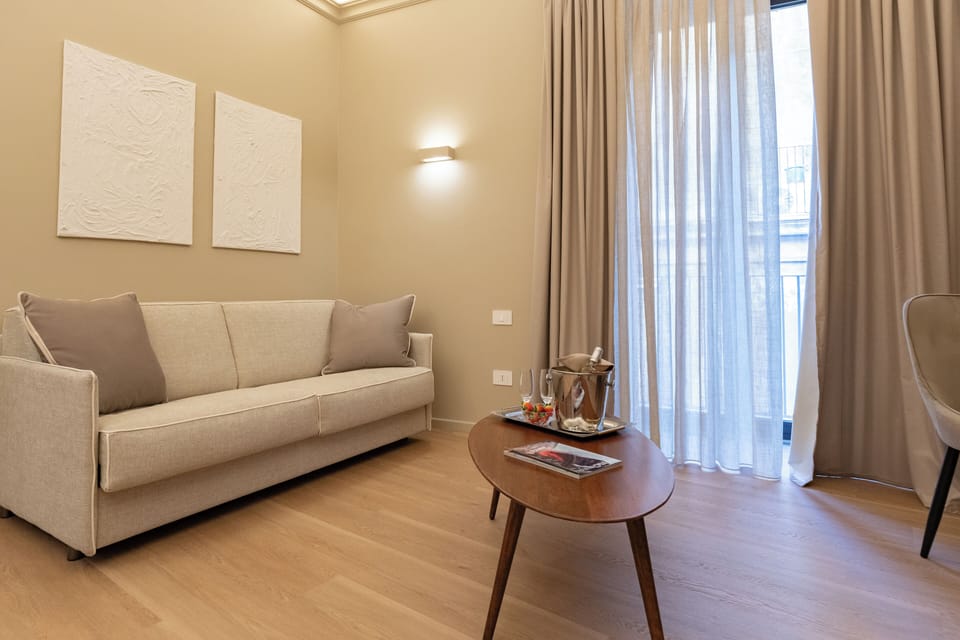 Luxury Suite, City View | Living area | TV