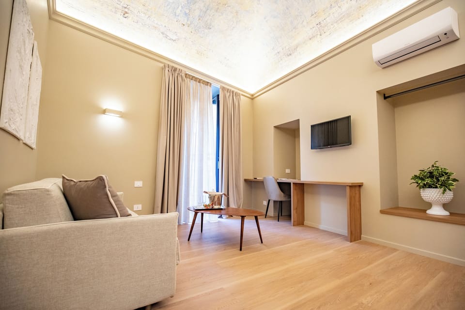 Luxury Suite, City View | Living area | TV
