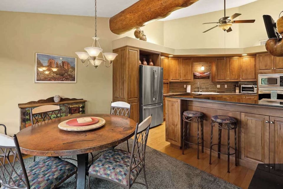 Gather around the dining table, creating memories in our well-equipped kitchen.